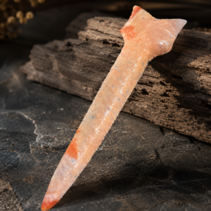 Handcrafted flintknapped Dalton Drill made from Agatized Florida Coral by Joel Robinson featuring translucent cream and soft orange natural coloration.