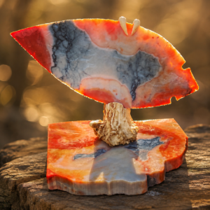 Handcrafted flintknapped Fulton Turkey Tail made from Flint Ridge Flint by Joel Robinson featuring blue-gray stone with translucent red and orange edges, mounted on deer antler and an Ohio-shaped stone base.