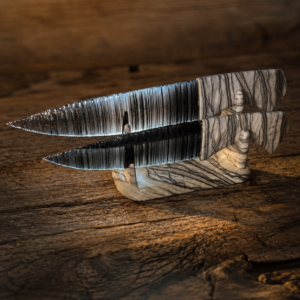 Handcrafted matching pair of Davis Creek Banded Obsidian knives by Joel Robinson with Picasso Marble handles and matching display stand.