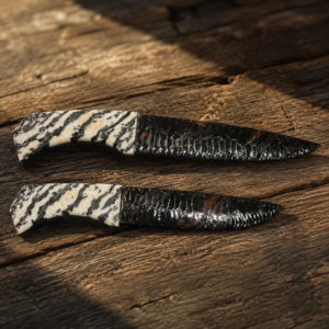 Handcrafted matching pair of Midnight Lace Obsidian knives by Joel Robinson featuring Zebra Marble handles and matching Zebra Marble display stand.