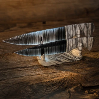 Handcrafted matching pair of Davis Creek Banded Obsidian knives by Joel Robinson with Picasso Marble handles and matching display stand.
